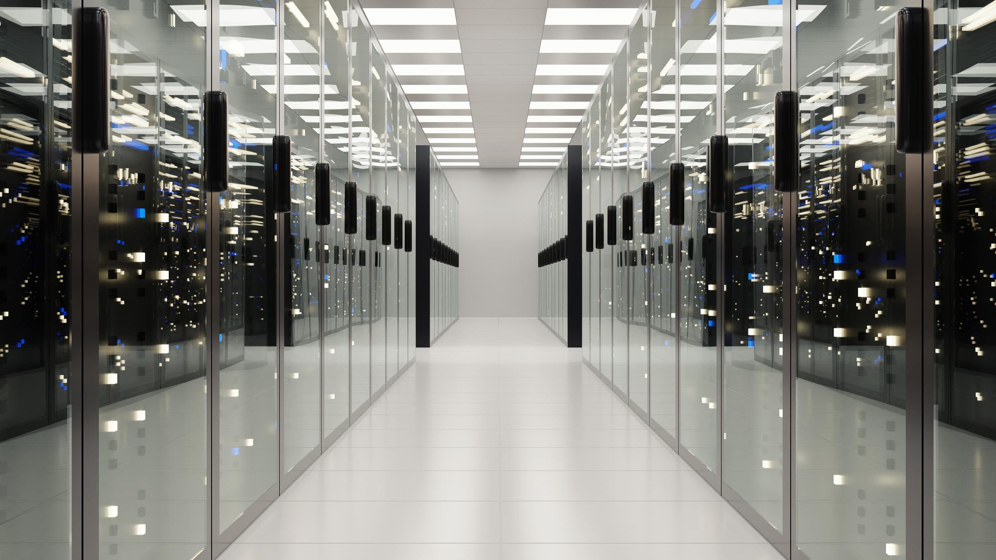 Data center aisle with mirrored glass server cabinets, LED status lights and raised floor for mission-critical infrastructure